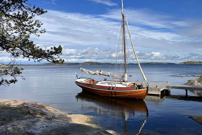 A sailboat docked on a body of water.