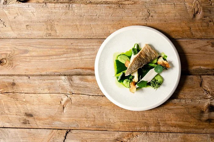 A plate of food on a wooden table.