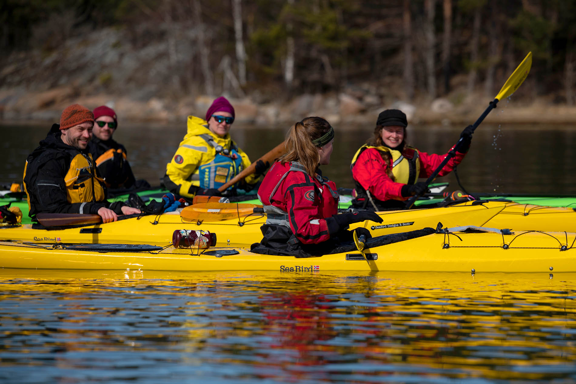A group of people in yellow kayaks