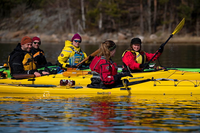 A group of people in a yellow kayak.