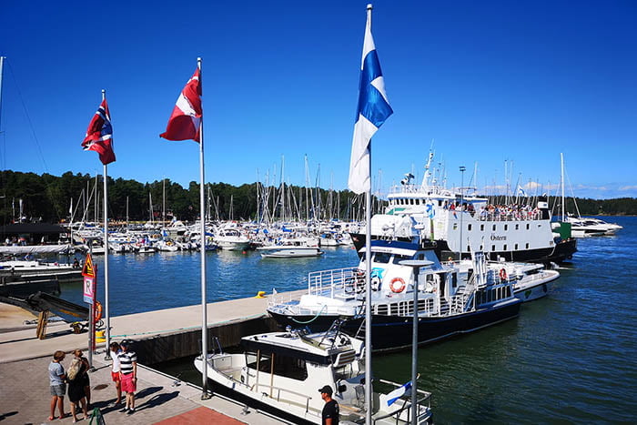 The flags of Nordic countries and a boat on a dock